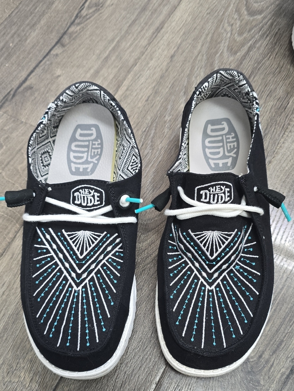 Hey Dude Black Canvas Slip-Ons with Teal & White Embroidery